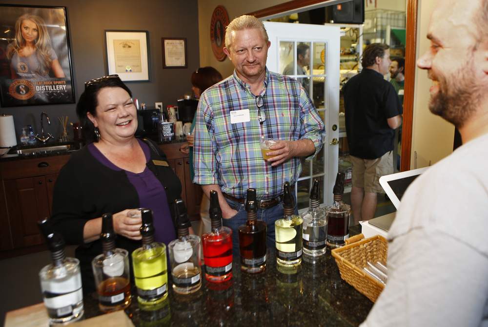 Bettina Buscemi, Day-Air Credit Union,  Don Crosthwaite, East Dayton Automotive and James Bagford, Stillwright Distillers, attend a Dayton Chamber of Commerce behind the scenes reception at Stillwright Distillery in Fairborn in 2015.  Photo by Ty Greenlees