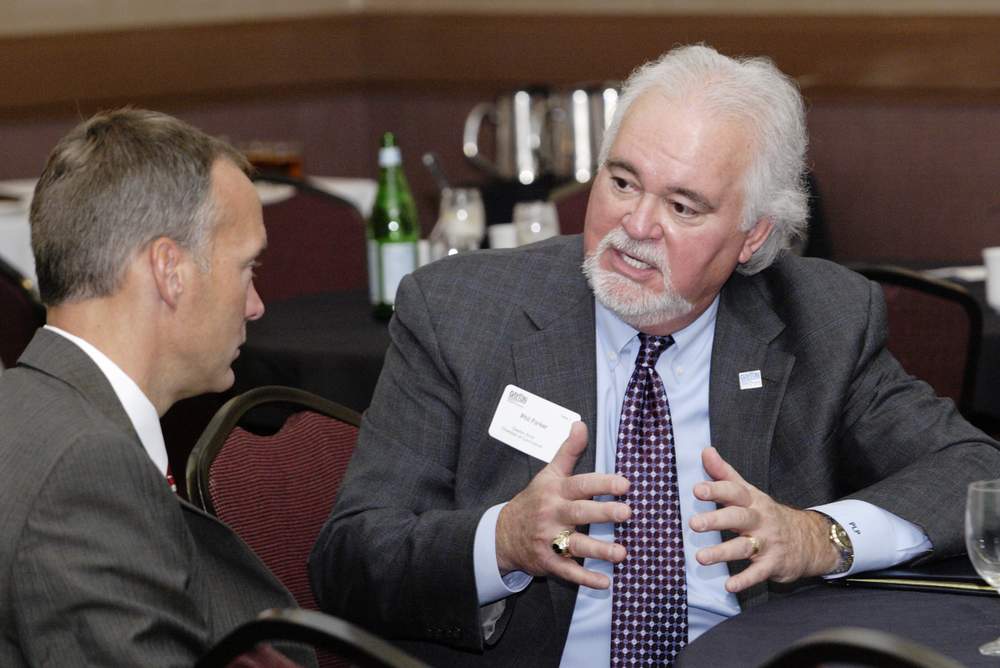 Dayton Development Coalition president &amp; CEO Jeff Hoagland and the Chamber's Phil Parker talk during a previous Government Affairs Breakfast. Photo by Peter Wine