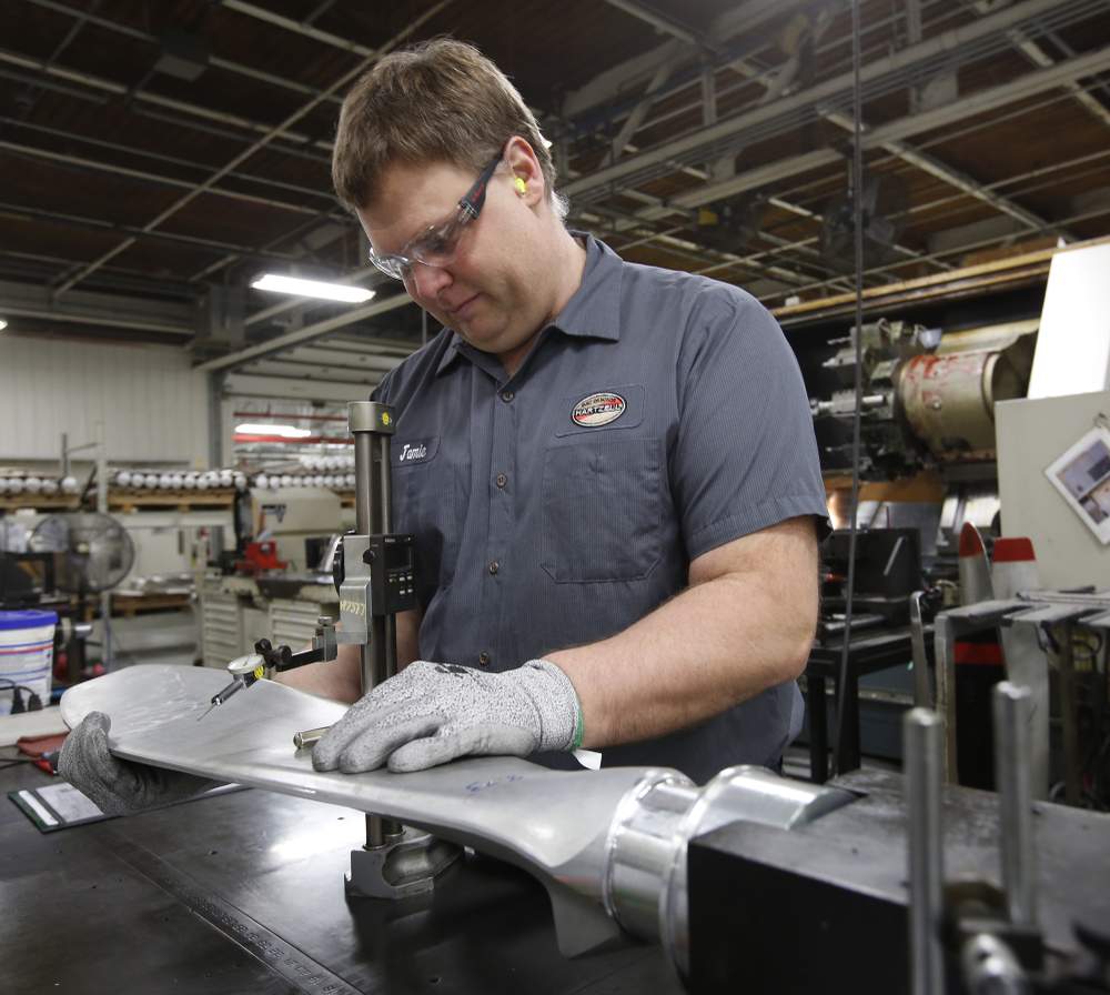 Machinist Jamie Rose measures one of more than 10,000 propeller blades that will be manufactured at Hartzell Propeller this year in Piqua. TY GREENLEES / STAFF