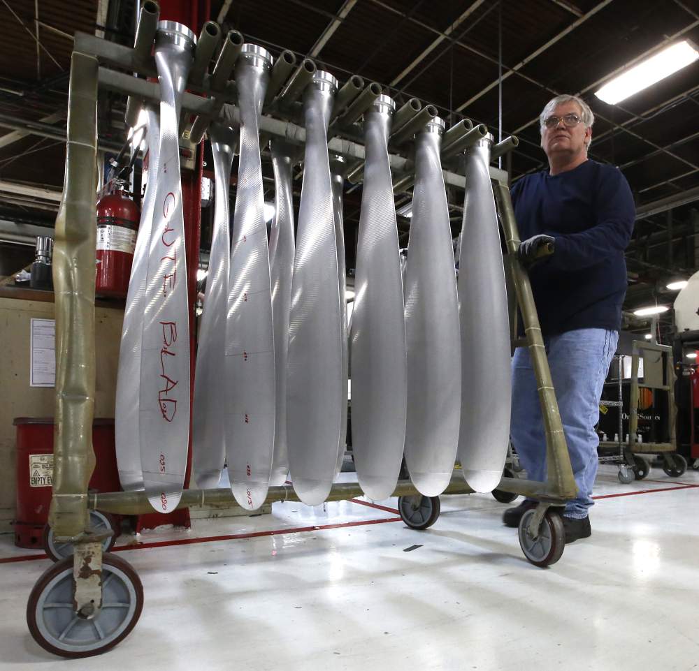 Machinist Mark Williams rolls a rack of propeller blades to a finishing area in the Hartzell Propeller factory in Piqua. TY GREENLEES / STAFF