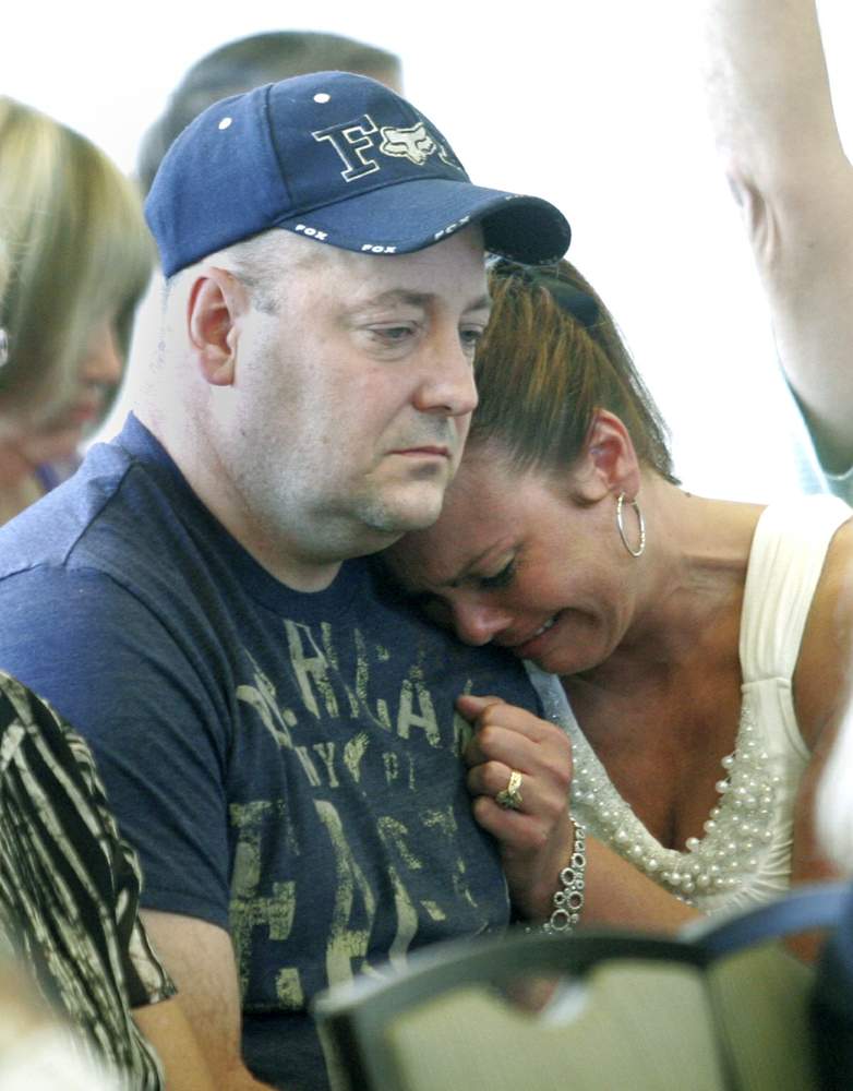 Laura Jenkins leans against her husband Dan at a 2010 meeting in Celina to address the lake's problems. Dan Jenkins was hospitalized after washing a family dog that swam in the lake. The dog later died. LISA POWELL / STAFF