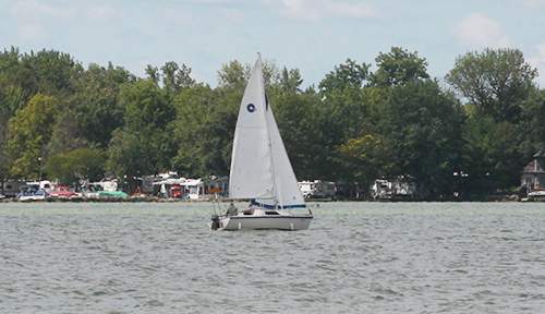 Boaters sail last week. In June, a woman who was boating and swimming fell ill. Testing this year for microcystin shows levels haven't been safe since April. CHRIS STEWART / STAFF