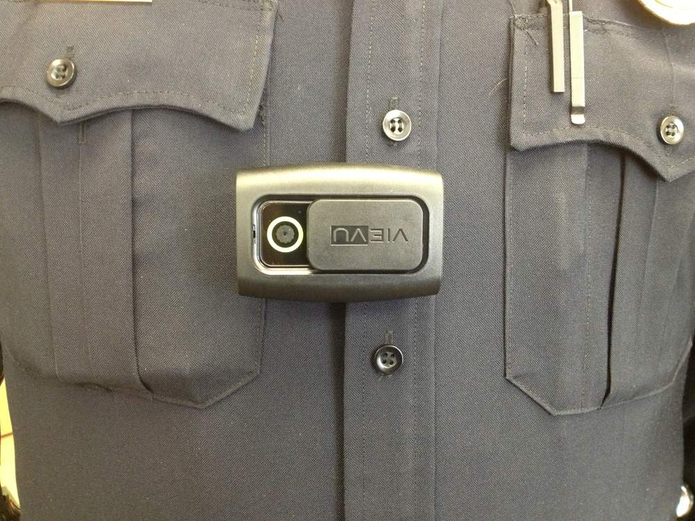 Sgt. Dustin Young of the Miami University Police Department displays a body camera used by patrol officers. LOT TAN / STAFF