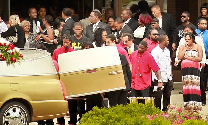 Pall bearers carry the casket of John Crawford III following funeral services at the Inspirational Baptist Church in Cincinnati on Aug. 23, 2014. JIM WITMER / STAFF