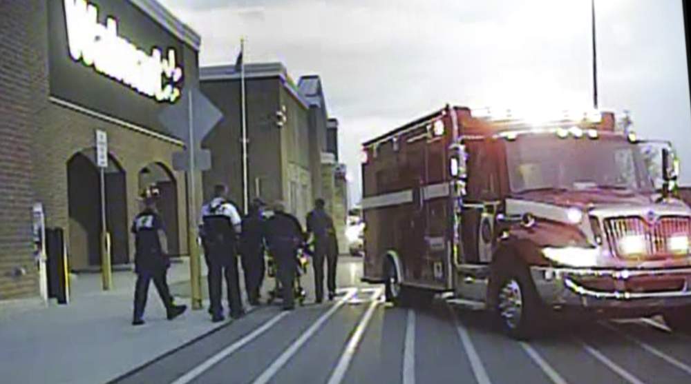 After the shooting of John Crawford III, an ambulance is seen outside the Beavercreek Walmart in this screen grab from police cruiser camera video. CONTRIBUTED