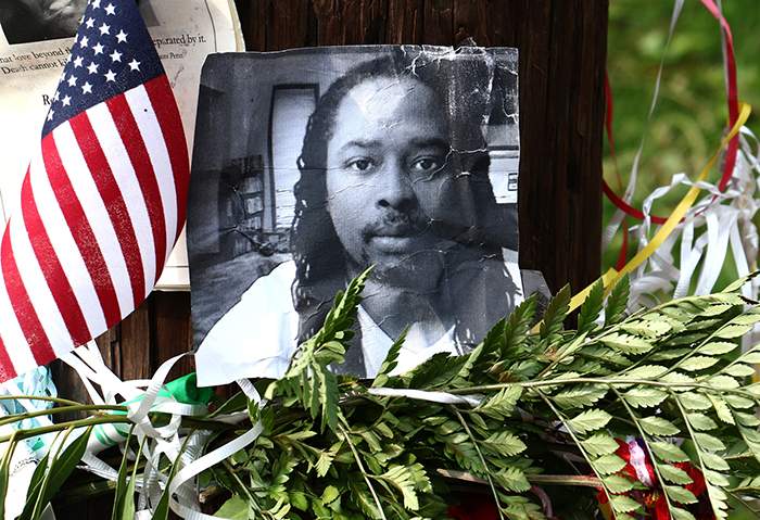 A photo of Samuel DuBose hangs on a pole at a memorial near where he was shot and killed in Cincinnati on July 19. TOM UHLMAN / ASSOCIATED PRESS